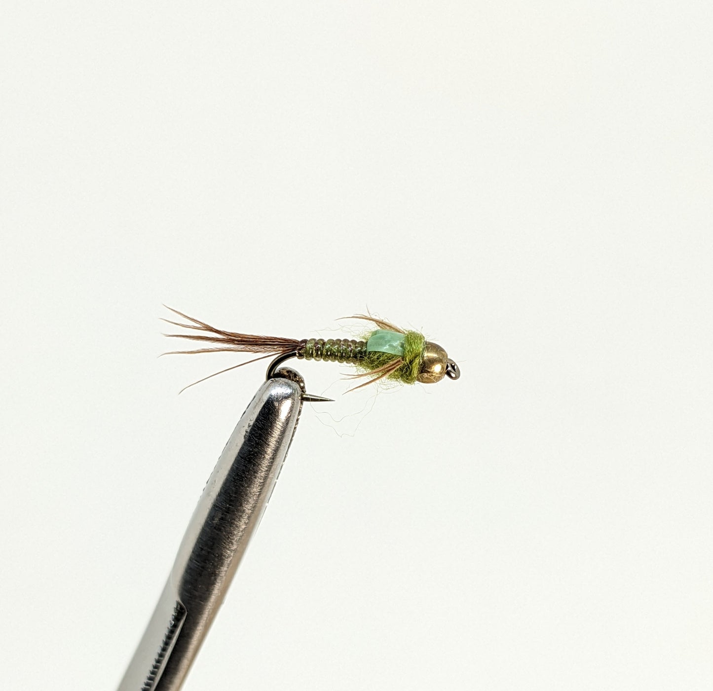 Nymphomaniac Bead Head Olive  Fly fishing fly. Dry, subsurface and nymph flies for anglers and fisherman. All the flies you need for sale online. Flies to buy online. Online fly fishing supplies. Catch fish with flies from Frontier Flies.