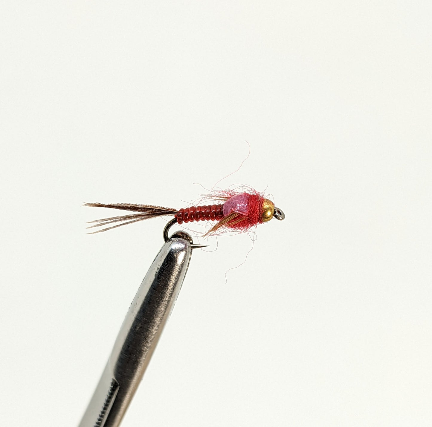 Nymphomaniac Red  Fly fishing fly. Dry, subsurface and nymph flies for anglers and fisherman. All the flies you need for sale online. Flies to buy online. Online fly fishing supplies. Catch fish with flies from Frontier Flies.